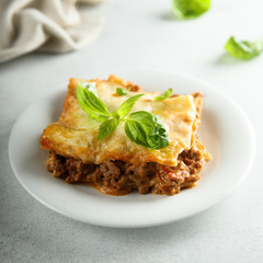 Traditional homemade lasagna served with fresh basil