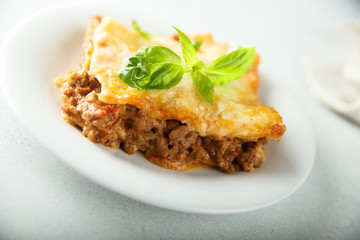 Traditional homemade lasagna served with fresh basil