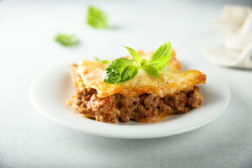 Traditional homemade lasagna served with fresh basil