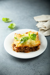 Traditional homemade lasagna served with fresh basil