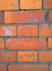 Obraz premium Red brick wall background. Old house. Construction industry. Building facade. Copy space. Grunge dirty textured surface. Close up. Brickwork with cement. Need for repair and renovation. Exterior