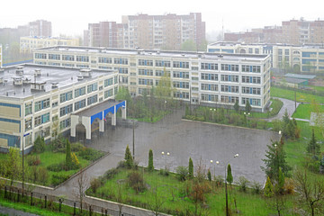 Empty schoolyard during heavy rain in spring. Moscow, Russia