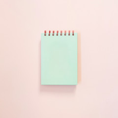 turquoise notepad on light pink background