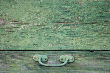 beautiful wooden background with cracked paint green with handle