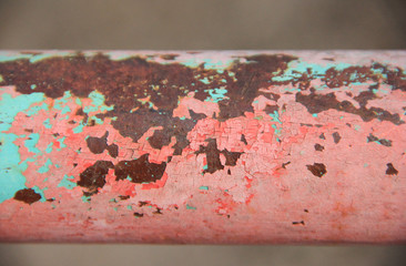 old bright rusty pipe. pipe with cracked light coral paint. pipe of light orange colour. concept of abandoned city. industrial background. grunge texture with cracked paint. bright industrial design.