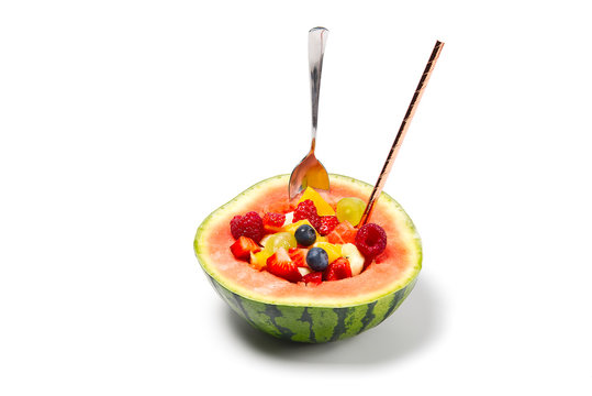 Watermelon filled with fresh fruit salad. isolated on white background