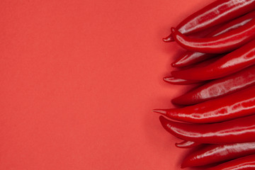 Red hot chili peppers on a red background