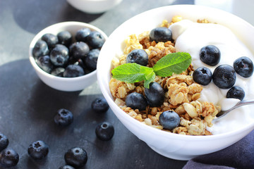 Healthy Breakfast bowl of muesli with blueberries and yogurt close up