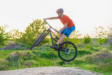 Extreme cycling concept, cyclist jumping on a mountain bike.