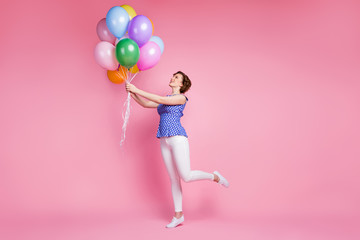 Fototapeta na wymiar Full length body size view of her she nice-looking attractive lovely slender cheerful cheery wavy-haired girl holding in hand bunch air balls having fun time isolated on pink pastel color background