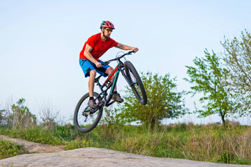Extreme cycling concept, cyclist jumping on a mountain bike.