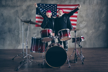 Photo of two retired people rock group photographing for american magazine hold usa flag patriots...
