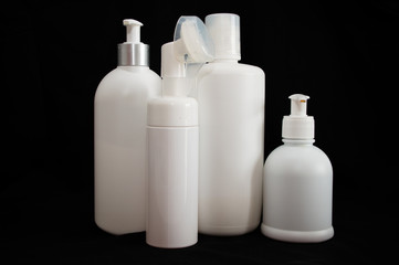 white plastic cosmetic bottle on black background