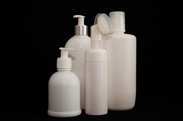 white plastic cosmetic bottle on black background