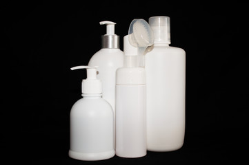 white plastic cosmetic bottle on black background