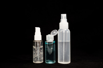 white plastic cosmetic bottle on black background