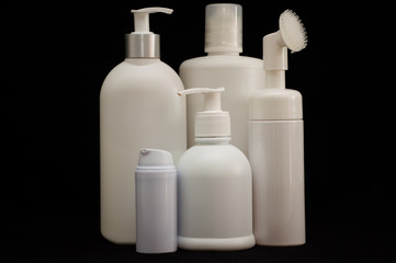 white plastic cosmetic bottle on black background