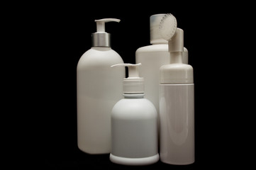white plastic cosmetic bottle on black background