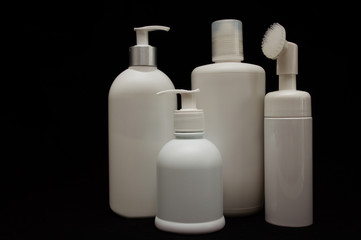 white plastic cosmetic bottle on black background