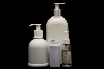 white plastic cosmetic bottle on black background