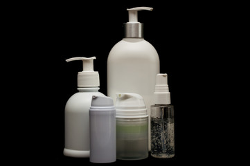 white plastic cosmetic bottle on black background