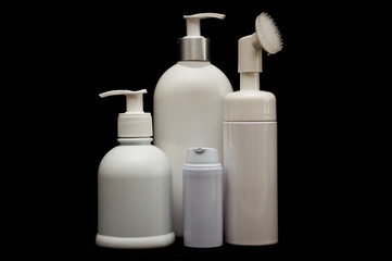 white plastic cosmetic bottle on black background