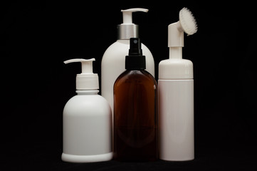 white plastic cosmetic bottle on black background