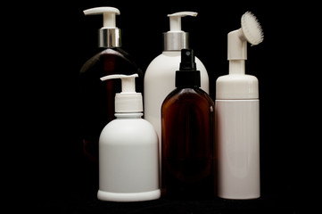 white plastic cosmetic bottle on black background