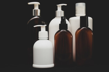 white plastic cosmetic bottle on black background