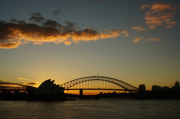 sydney harbour bridge and opera house at sunset