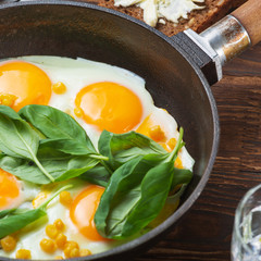 Fried eggs for breakfast close-up. Wooden table. Healthy eating