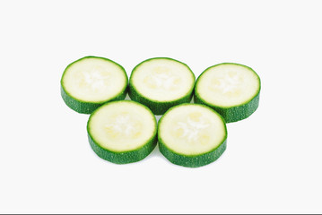 fresh green zucchini slices isolated on white background
