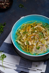 Bowl of chicken soup with vermicelli and vegetables