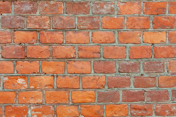 Weathered stained old brick wall background in day