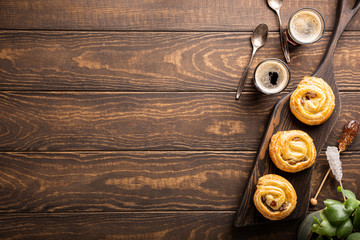 Food background with fresh pastry sweet swirl buns with raisins for breakfast or brunch and coffee. Top view, copy space.