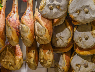 Prosciutto Nationale traditional ham or speck, whole pork pig leg smoked and unsliced, hanging