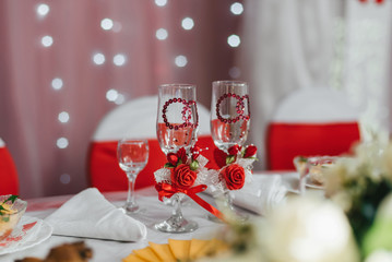 decorated wedding glasses on the festive table in the restaurant