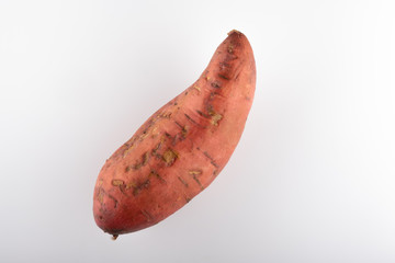 sweet ripe sweet potatoes close up on a white background