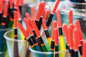 fishing floats in bright colors on the counter of a fishing store © OlegDoroshin