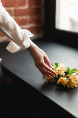 The girl touches a yellow flower. Girl and flower. A yellow flower in a girl's hand. 