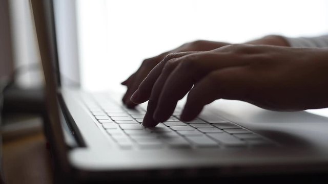 hands touch typing on a keyboard