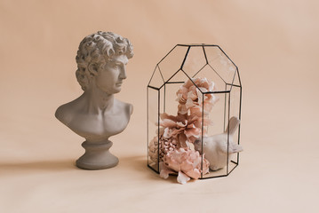 An ornamental composition of artificial flowers. Home decoration. Decor for the studio. Classic decor. Artificial flowers. Decorative flowers with own hands. David's head. 