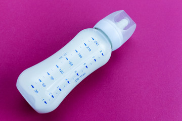 Bottle of milk for baby on color background