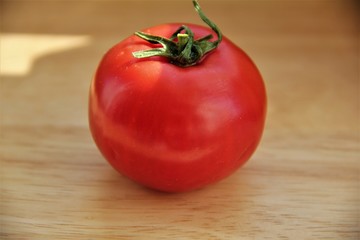 one red tomato on a wooden Board © Tatiana Vasilek