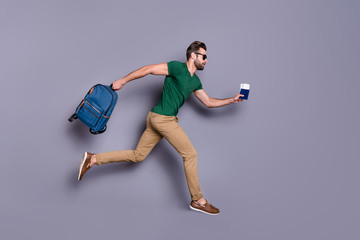 Full body profile side photo of serious guy jump run dont want miss check in passing board hold...