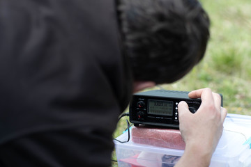 An Amateur radio operator sets up a receiver in the suburbs.