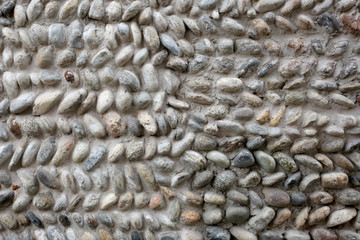 ancient wall made with river peebles with copy space for your text