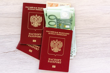 Russian passports with foreign money on the table.