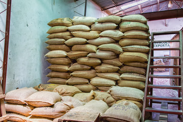 JUAYUA, EL SALVADOR - MAY 05: Coffee beans packed in a burlap sacks in a coffee mill in Juayua, El...