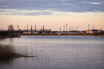 Rural dock view of  cranes in late evening sunset.
